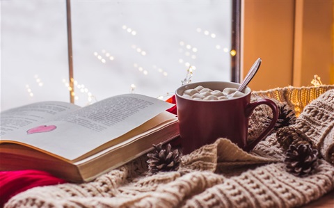 red-cup-with-cocoa-marshmallows-wooden-table-with-scarves-old-book-home-comfort.jpg