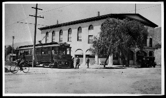 Pacific Electric (PE) car in front of the First National Bank Building and Opera House.